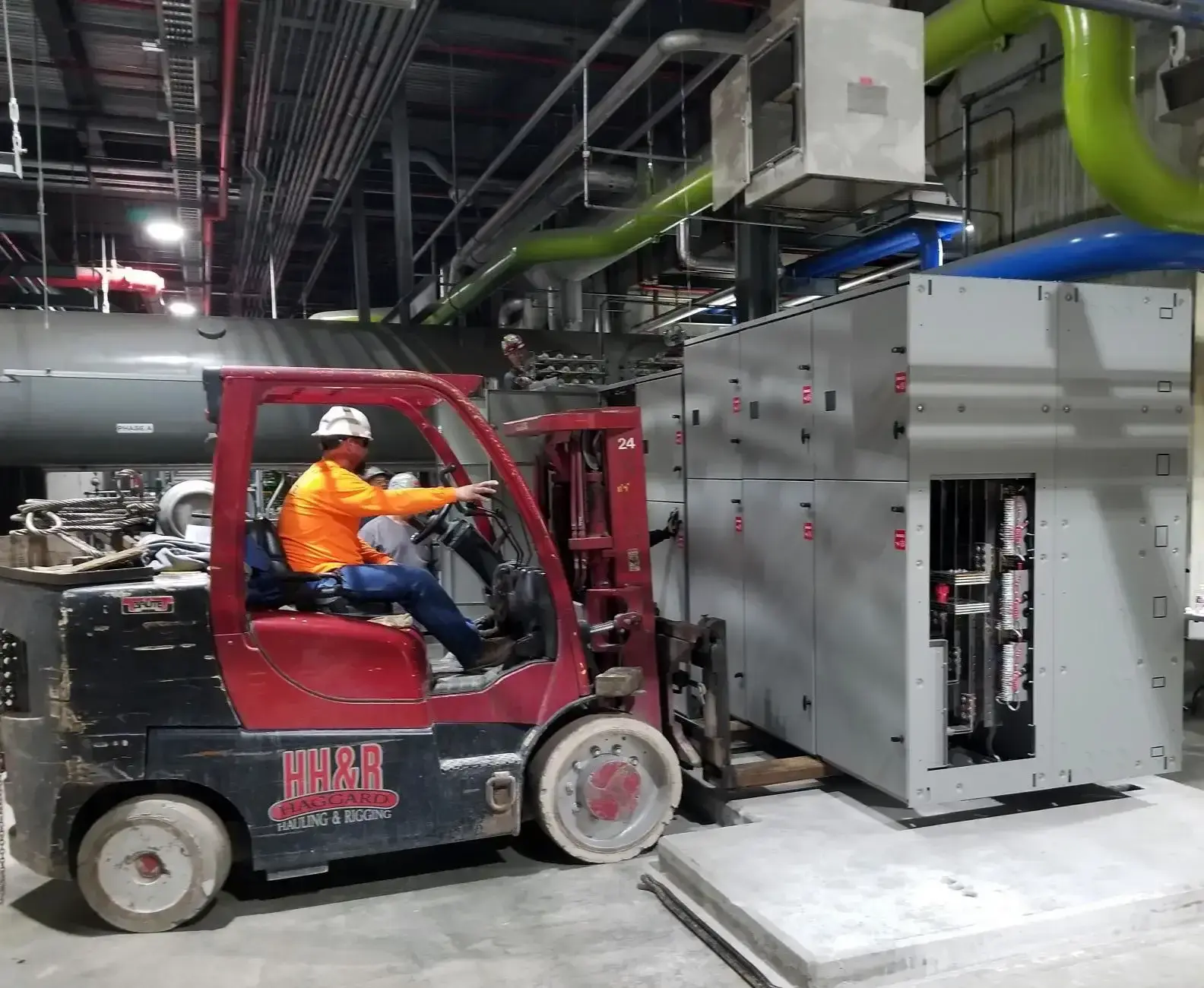 Tech on forklift lifting cabinet